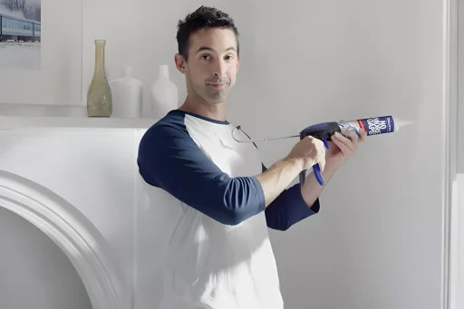 a man using caulk gun